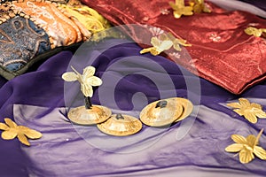 Close-up of zills for bellydancing on a purple veil with arabic cushions