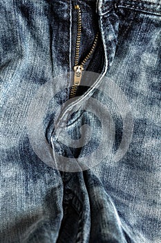 Close-up zipper open on blue jeans, denim texture, zipper jeans pants