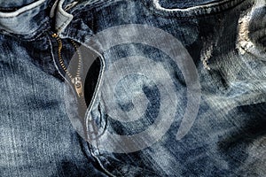 Close-up zipper open on blue jeans, denim texture, zipper jeans pants