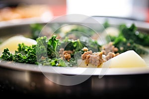 close-up zuppa toscana, steam rising, kale visible