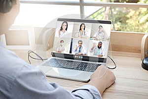 Close-ups on the computer screens a group of doctors greets the patients via online video calls.