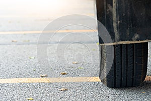 Close of used car tires on asphalt road with sun light in the morning time.