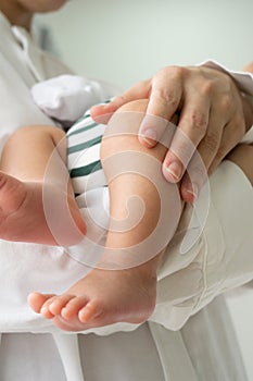 Vertical of baby left leg with handle gently