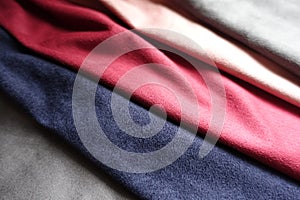 Close view of artificial suede in red, pink, blue, grey