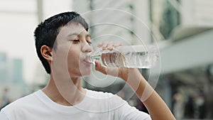 Close View of the Asian Teenage Guy Outside Drinking Water in Training.