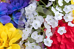 Close view of an assortment of artificial flowers with white forget me nots