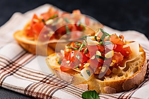 close view of bruschetta with pickled garlic on a crisscrossed napkin