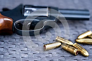 Close view of bullets and handgun.
