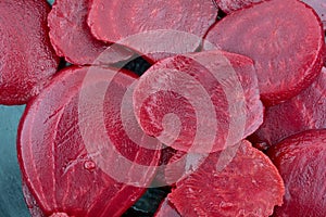 Close view of canned sliced beets in a cast iron skillet