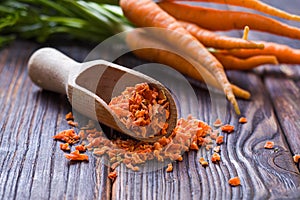 Close view carrot seasoning in wooden spoon