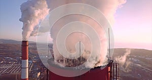 Close view of Central Heating and Power Plant chimney top with steam. Dawning