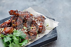 Close view of chicken wings with spicy sauce, copy space