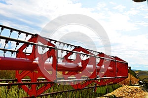 Close view on the combine harvesting the colza