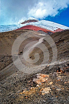 Close view of the Cotopaxi volcano, it`s slopes, rocks and safe house, on an cloudy yet sunny day, Cotopaxi National Park, Ecuador