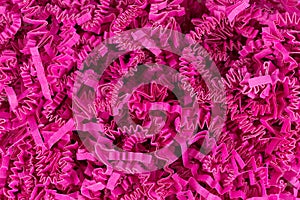 Close view of dark pink shredded crinkle paper