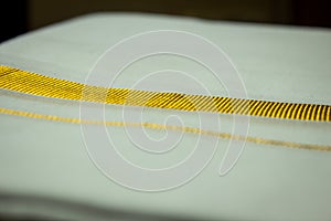 Close view of the dhoti with gold threaded border. Dhoti is a traditional south indian dress wore by men during festivals,