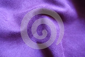 Close view of draped violet faux suede