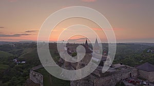 Close view from drone of Kamianets-Podilskyi Caslte with air balloon in the sky