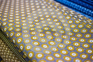 Close view of a fabric roll with a traditional African pattern print