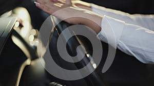 Close view of female fingers caress and knock car handlebar