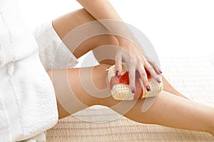 Close view of female scrubbing her legs photo