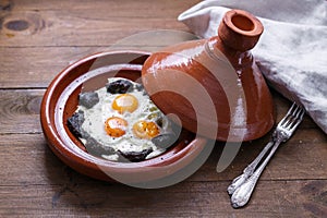Close view of fried egg and beef in tajine dish, traditional Moroccan dish