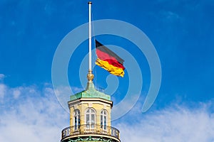 Close view on German Flag at Halfmast, auf Halbmast, on the top of Castle Karlsruhe. District Karlsruhe, Baden-WÃÂ¼rttemberg,