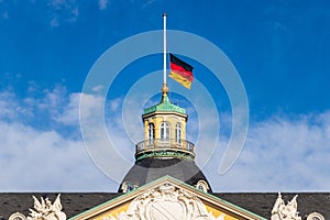 Close view on German Flag at Halfmast, auf Halbmast, on the tower roof of Castle Karlsruhe. Baden-WÃ¼rttemberg, Germany