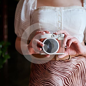 Close view of a girl holding a camera