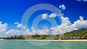 close view of green hilly island cloud shadows against blue sky