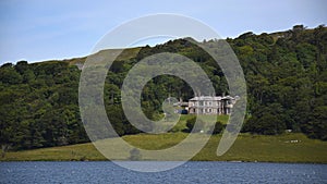 Close view of house enclosed by woodland at Malham Tarn