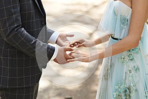 Close view of male and female hands. Young businessman holding hands of a young woman. Closeup cropped photo of two