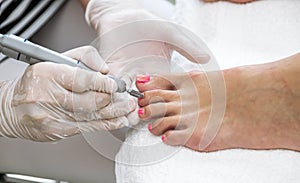 Close view of nails and feet with nail file.