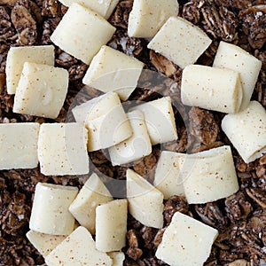 Close view of a portion of sweet chocolate granola with white chocolate pieces
