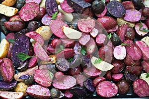 Close view of raw sliced purple and pink potatoes.