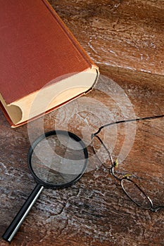 Close View of Reading Glasses and Magnifier on Large Antique Book