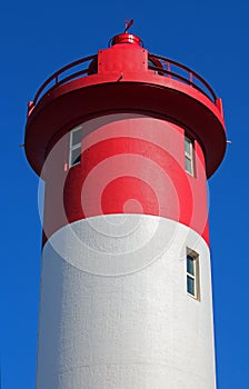 CLOSE VIEW OF RED AND WHITE LIGHTHOUSE