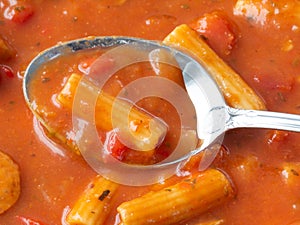 Close view of rigatoni pasta and sausage with a spoon top view