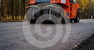 Close view on the road roller working on the new road construction site. Selective focus. Closeup