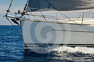Close view at sailboat bow with hoisted genoa is sailing in the Mediterranean photo