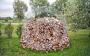 Close view of stack of firewood on the grass