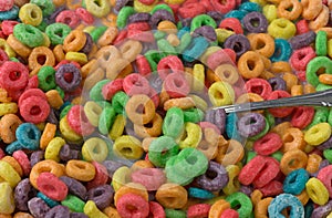 Close view of sugar coated fruity flavored cereal with milk and