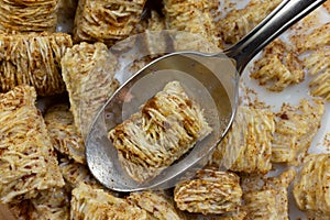 Close view of taking a spoonful of wheat cereal with milk and cinnamon