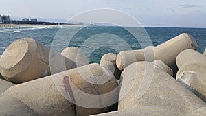 Close view of tetrapod stones on the sea shore to prevent coastal ersosion