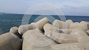 Close view of tetrapod stones on the sea shore to prevent coastal ersosion