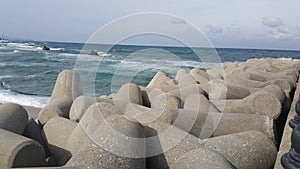 Close view of tetrapod stones on the sea shore to prevent coastal ersosion