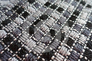 Close view of grey embroidered fabric