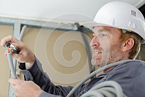 close view tradesman cutting electricity cable