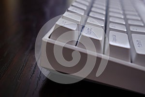 Close view of a white mechanical keyboard with ESC key in the front