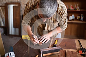A joiner using his chisel
